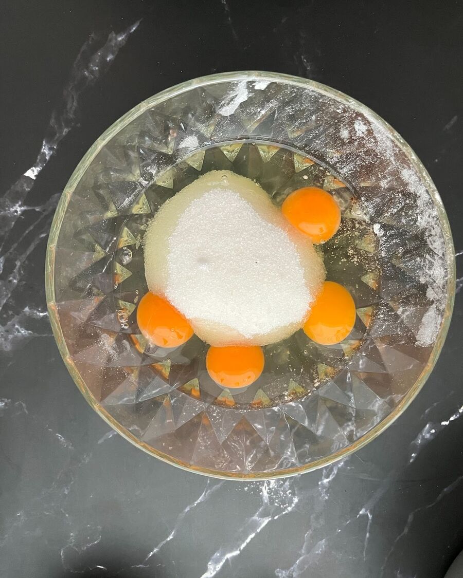 Combine eggs and sugar in a large bowl, whisking them together until the sugar is fully dissolved and the mixture becomes smooth.