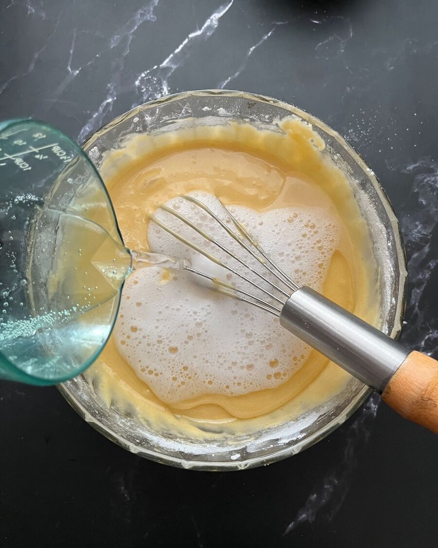 Add rice cooking oil, milk, and soda water to the pancake batter mixture.