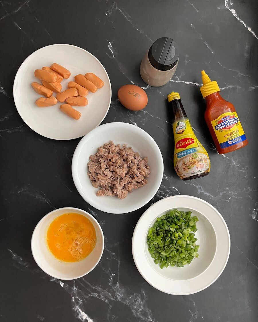 Prepare the savory filling by stir-frying minced pork, eggs, sausage, spring onion, soy sauce, Sriracha sauce, and ground pepper.