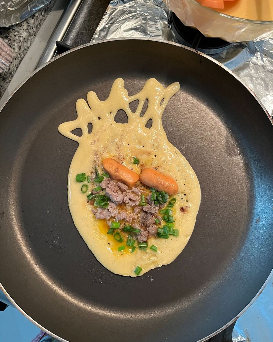 Add sausage, minced pork, and spring onion over the pancake (for savory filling). For sweet fillings, substitute these with pandan or custard pastry creams.