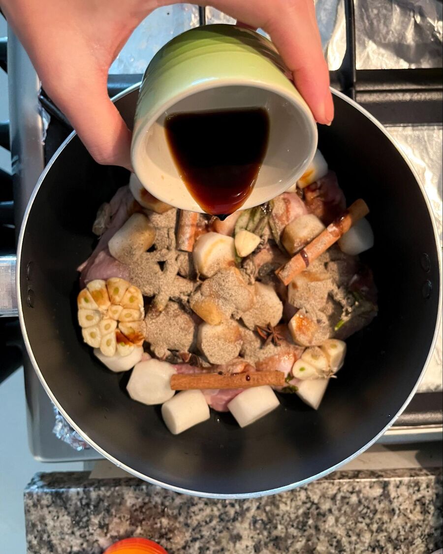 Place a soup pot over medium-high heat. Add the chicken, chopped radish, cinnamon sticks, garlic, coriander roots, star anise, palm sugar, sweet soy sauce, soy sauce, salt, and ground pepper..