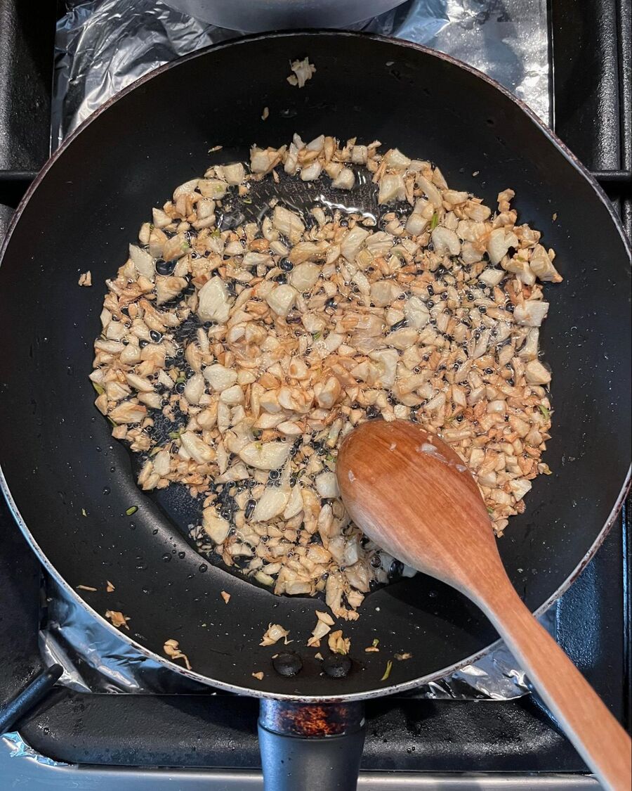 Next, using a small pan, heat ½ cup of cooking oil over medium-high heat. Add the minced garlic and keep stirring until it becomes fragrant and slightly yellow in color. Once done, remove the pan from the heat.