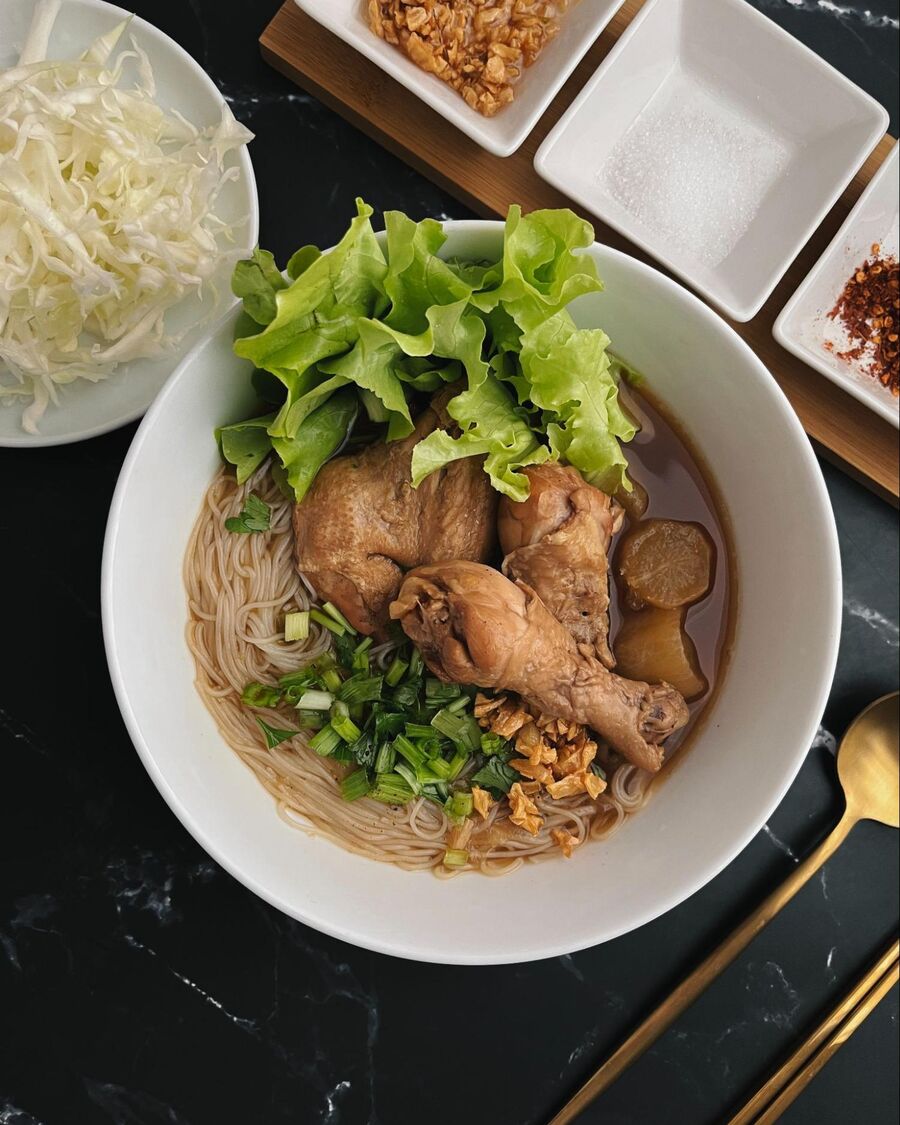 Place the noodles into the bottom of the bowl. Pour the soup over them, and top with chicken, radishes, vegetables, spring onion, and fried garlic. Then, you can adjust the taste to your liking by adding sugar and chili flakes as much as you like. Enjoy!