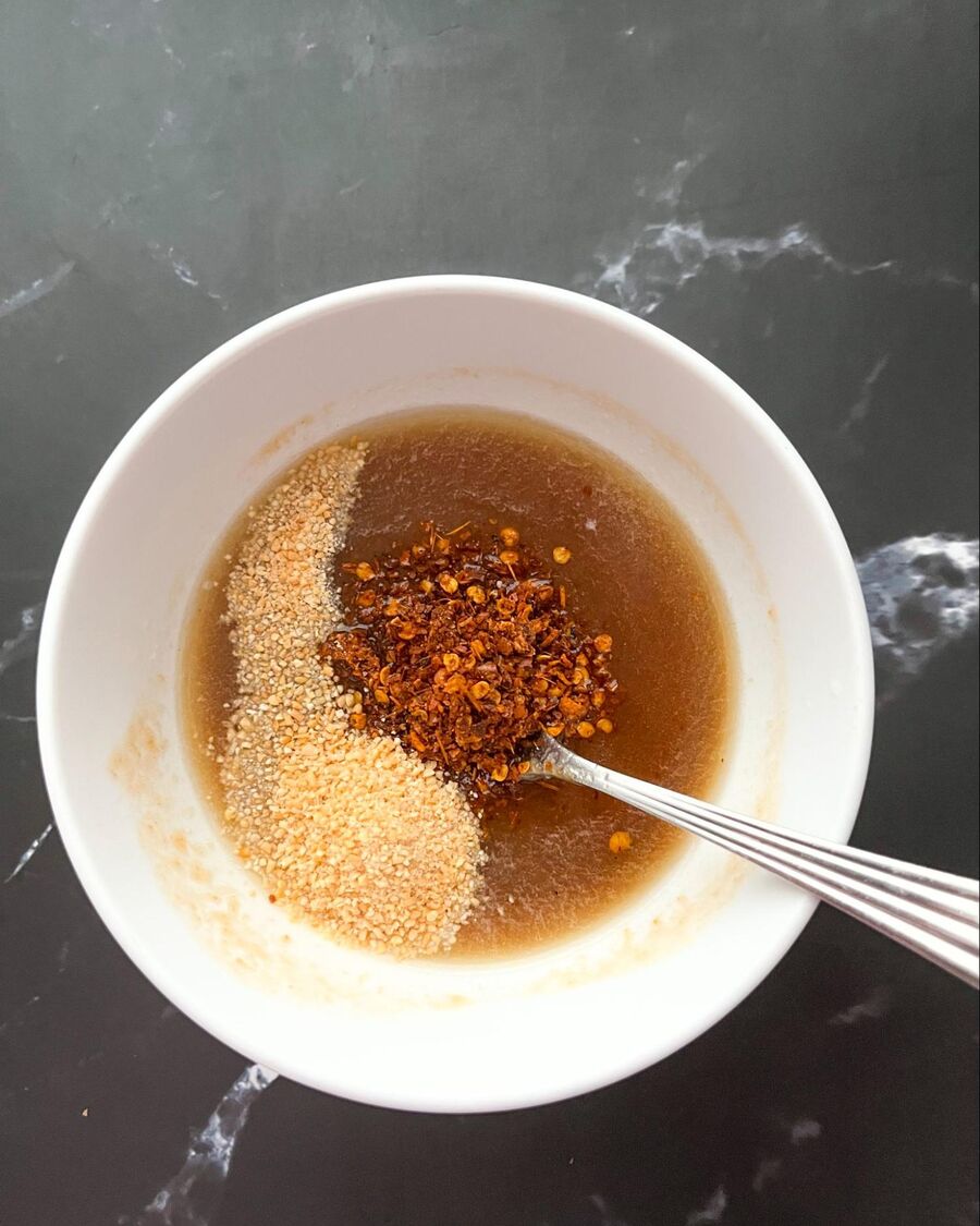 Add the roasted chili flakes and toasted rice powder, then stir to combine. Taste and adjust until you achieve the desired balance. The flavors should harmoniously blend smoky spiciness, sourness, and sweetness.