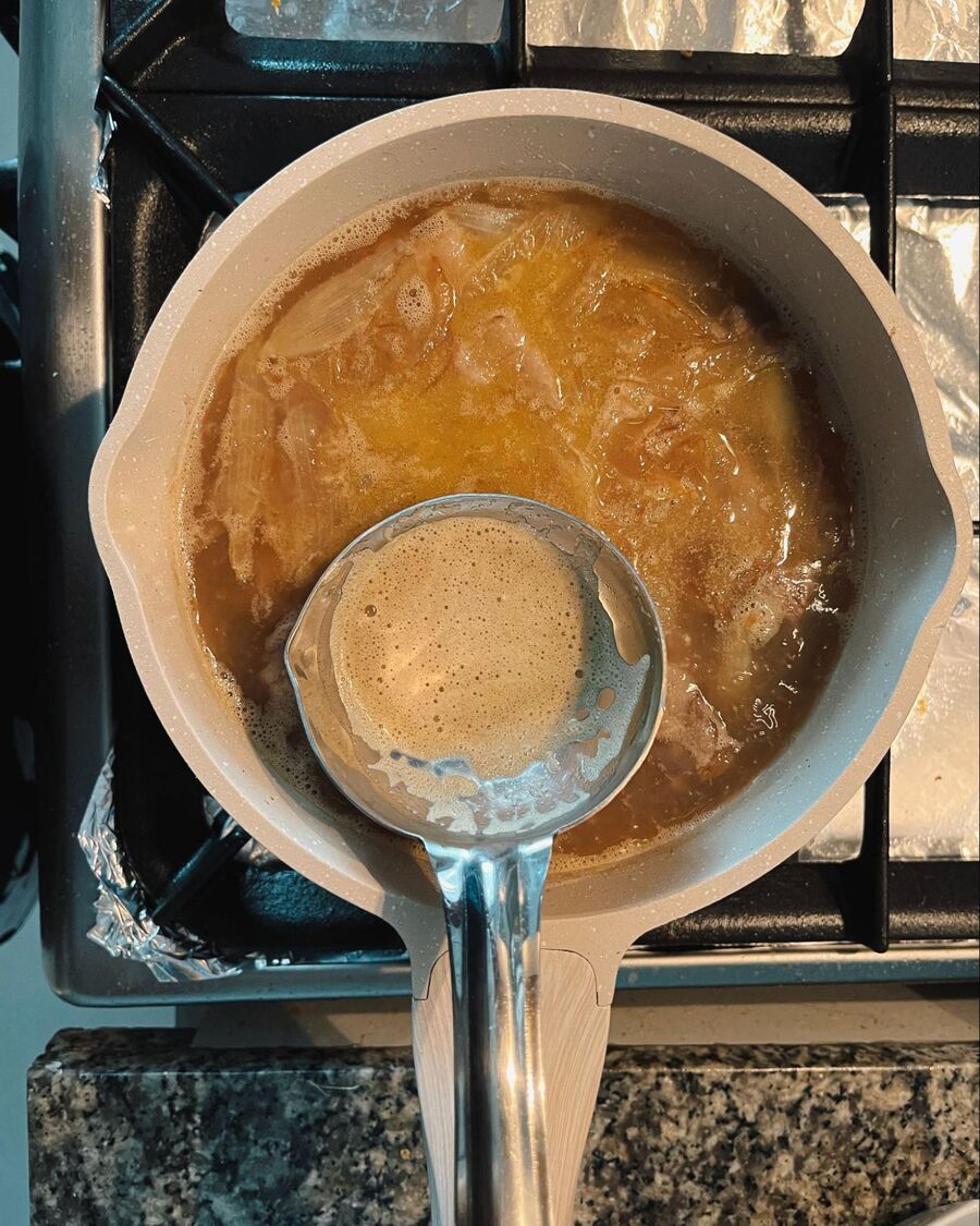 Once the soup starts to boil and bubbles appear, skim off any foam or impurities from the surface of the pot. Then, continue boiling the soup.
