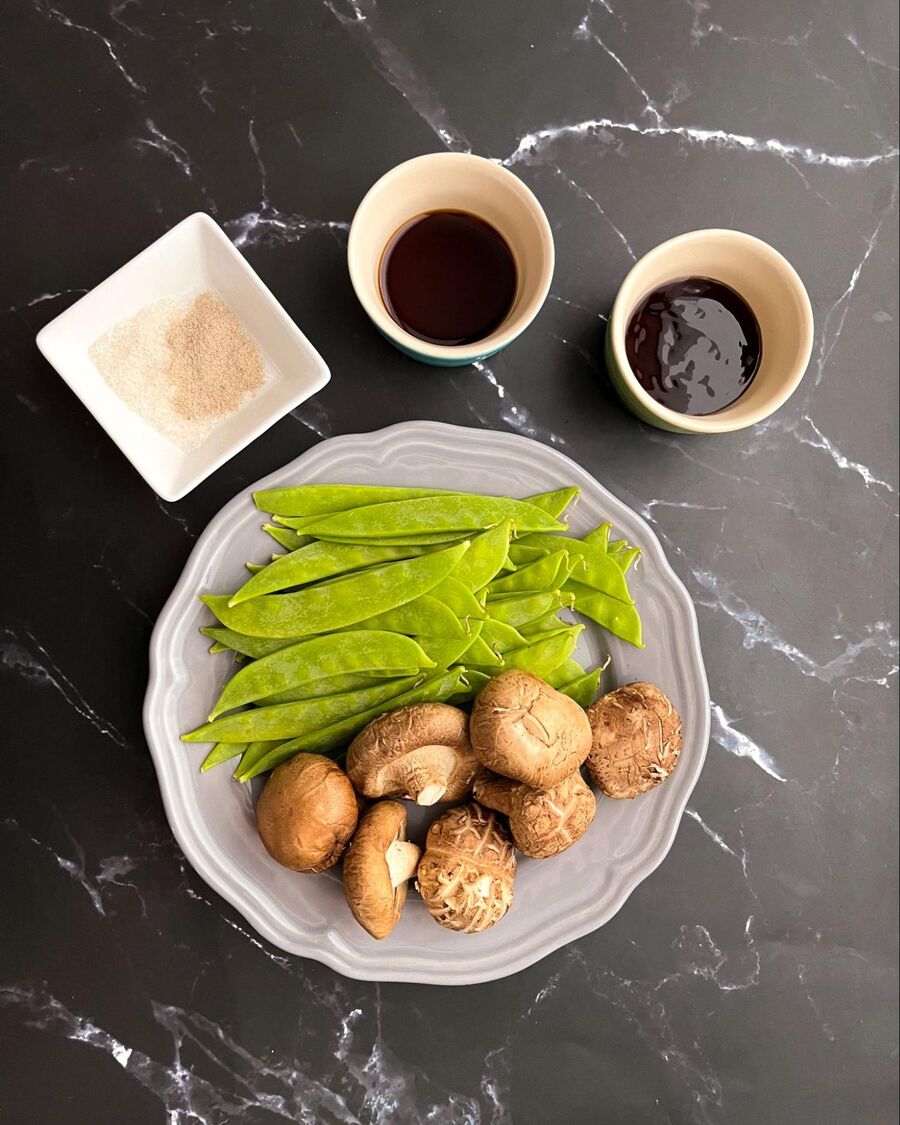Begin by gathering all the necessary ingredients for Thai stir-fried snow peas and mushrooms in oyster sauce. 