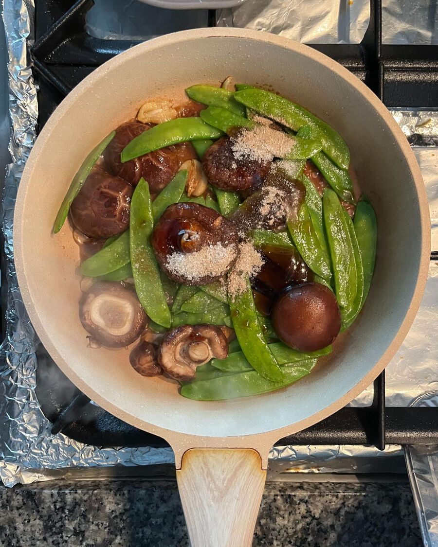 Add the mushroom sauce, soy sauce, sugar, and ground pepper to the vegetables. Stir to combine thoroughly.
