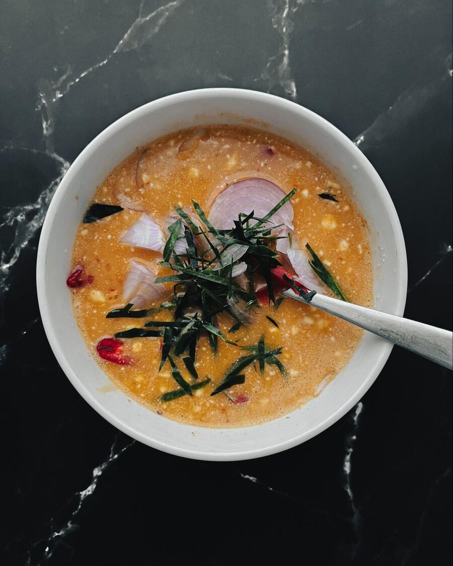 Add the red onion, kaffir lime leaves, and chili pepper to the eggs, and mix them well.