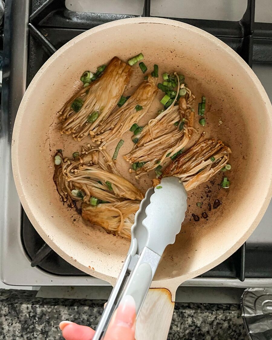Add the chopped spring onions, remove the pan from the heat, and gently flip the mushrooms to combine everything.