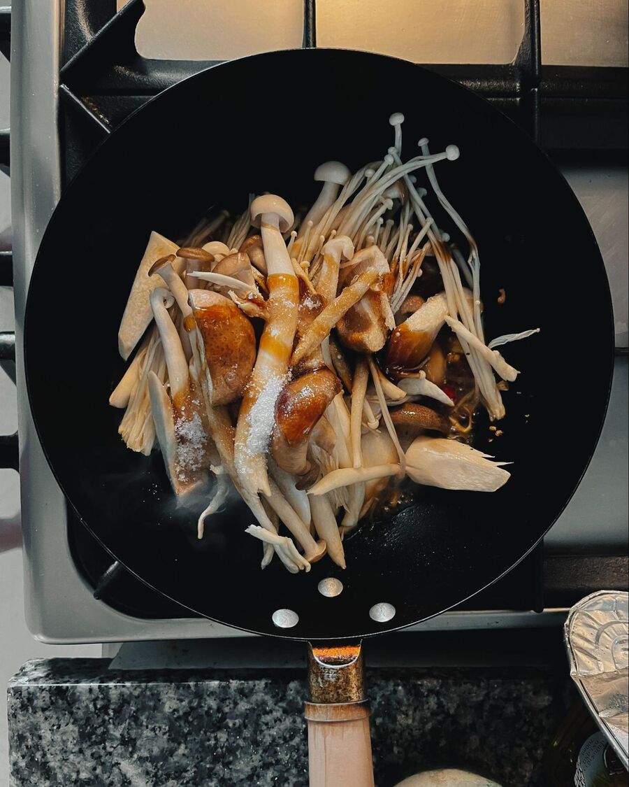 Add the mushrooms to the pan, then stir in the oyster sauce, soy sauce, fish sauce, and sugar.