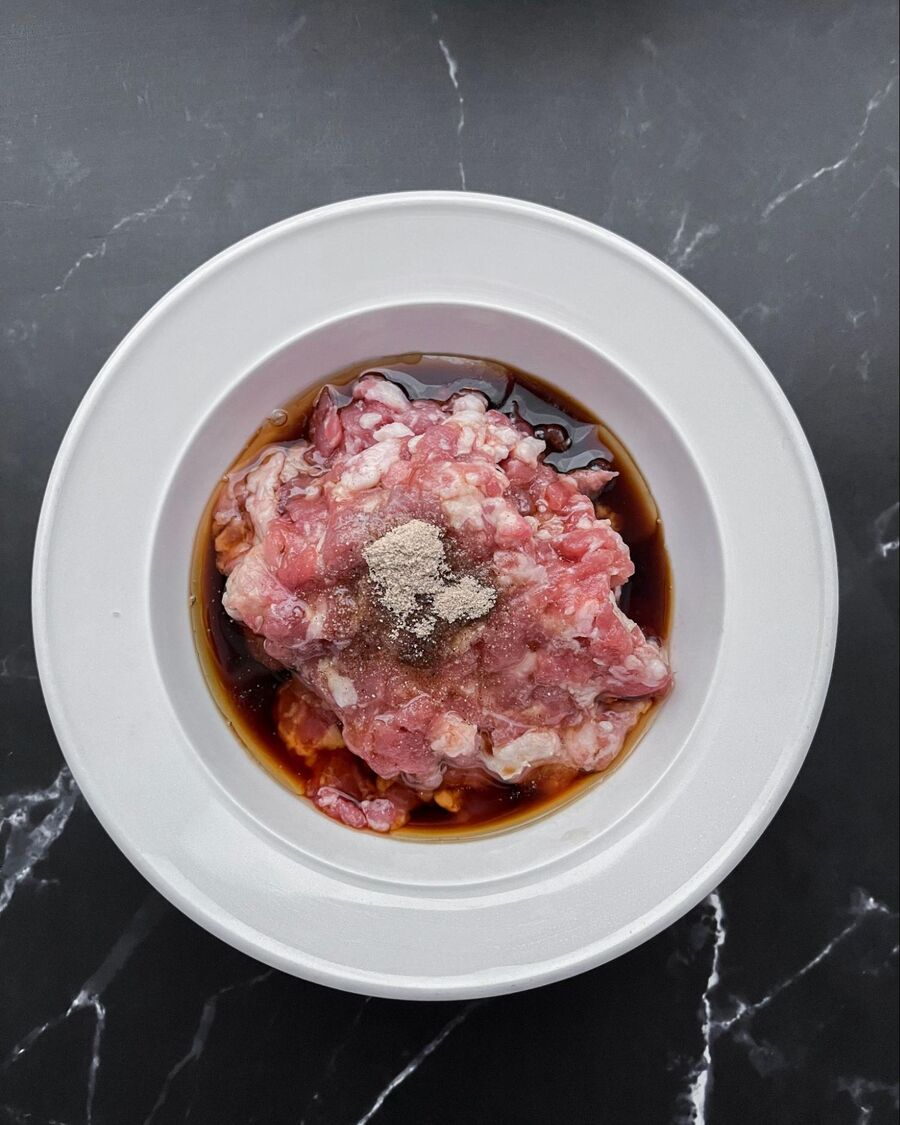 Marinate the minced pork in a small bowl with sesame oil, oyster sauce, and ground pepper for about 5 minutes before cooking.
