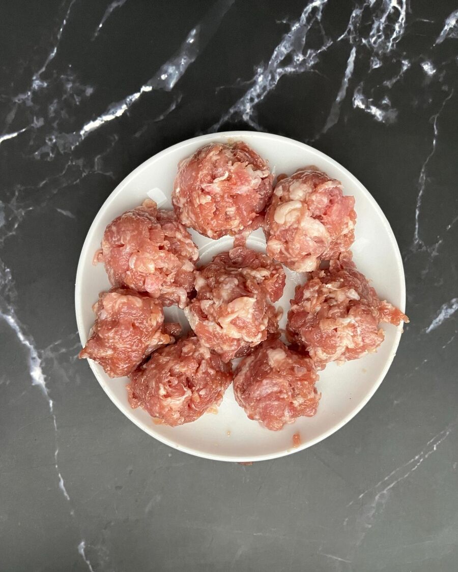 Then, use an ice cream scoop to form meatballs. This ensures they are all the same size.
