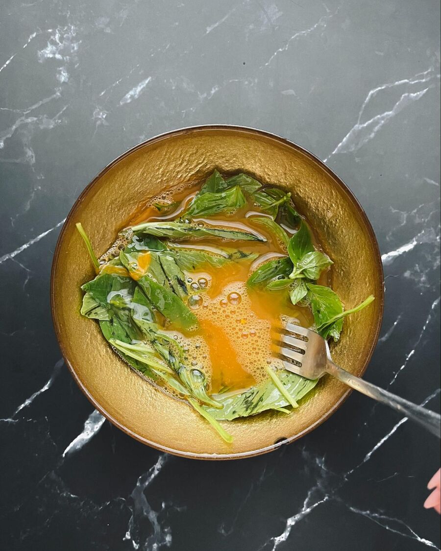 Add fish sauce and sweet basil, then mix them together well.