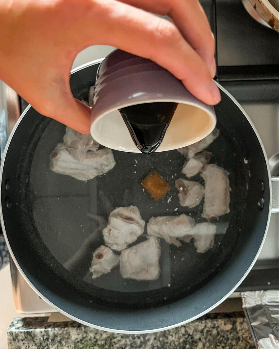 Place a soup pot over medium-high heat. Add the pork spare ribs, chopped radish, dark soy sauce, soy sauce, salt, and the pork broth cube.