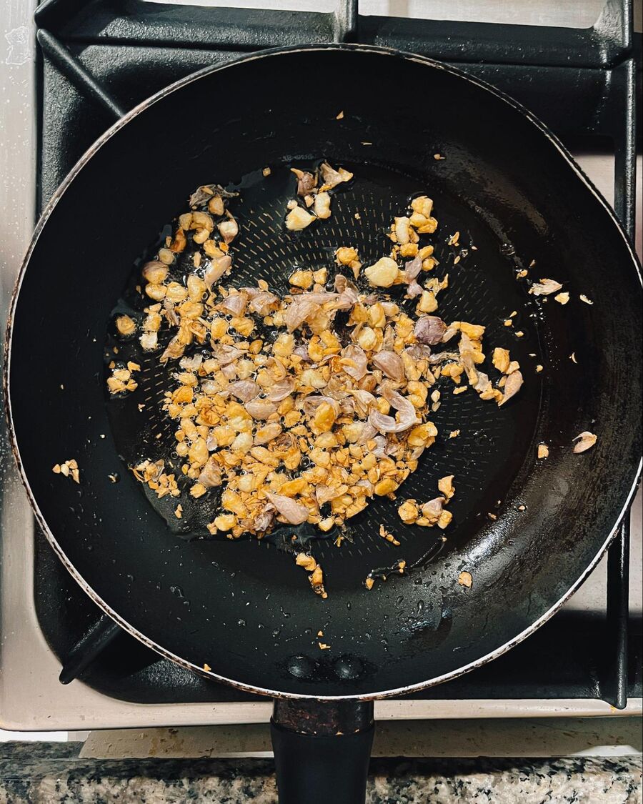 Next, heat ½ cup of cooking oil in a small pan over medium-high heat. Add the minced garlic and stir constantly until it becomes fragrant and slightly golden. Once done, remove the pan from the heat.