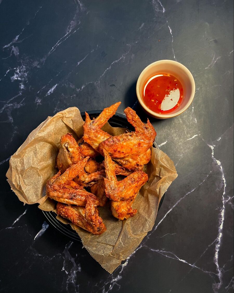 Serve the chicken wings with sweet and sour sauce on the side for dipping.
