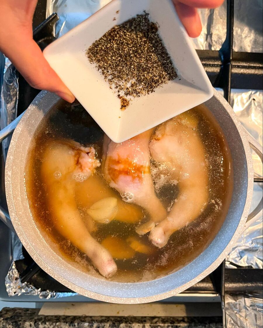 Next, add the salt and ground black pepper. Let the chicken simmer gently for about 20-30 minutes, allowing the flavors to meld and the chicken to become tender.