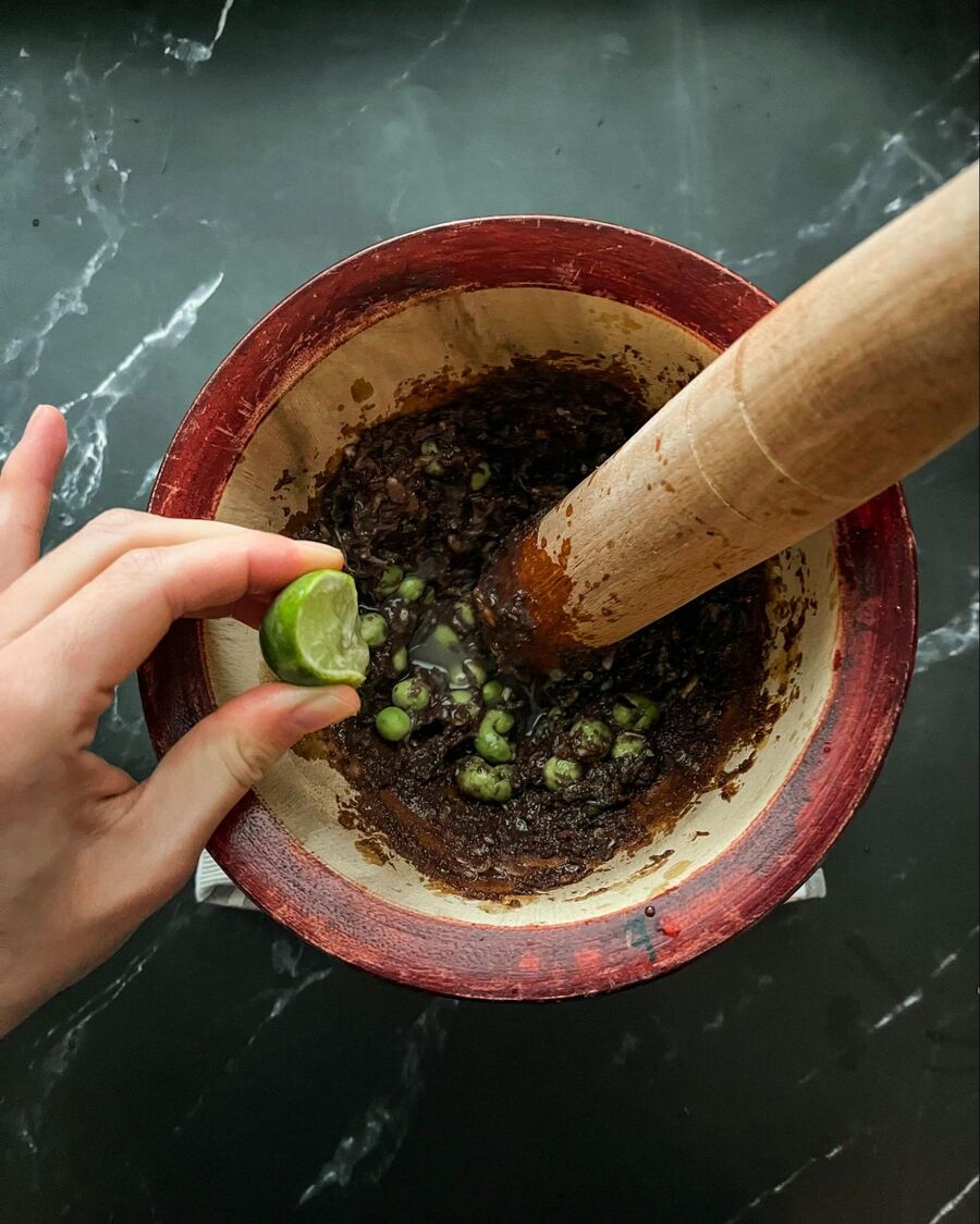Then add about 3–4 tablespoons of fresh lime juice and mix everything together in the mortar using a spoon.