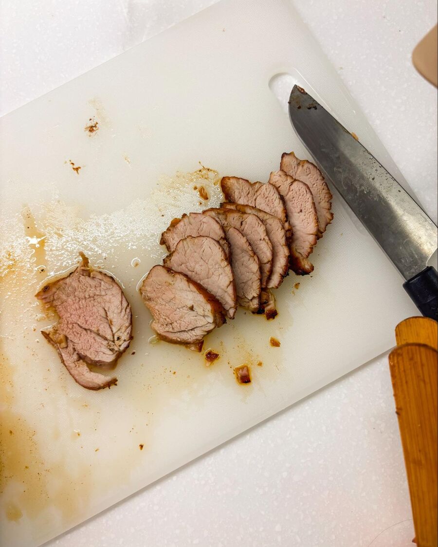 Once the pork is cooked through, remove it from the air fryer and slice it into thin pieces.