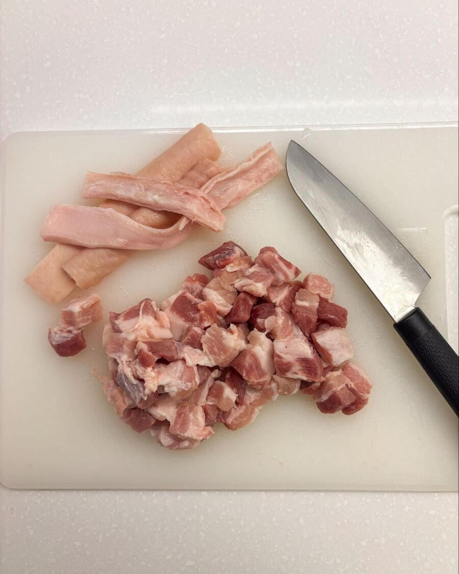 Trim the skin off the pork belly, then slice the meat into 1-inch thick pieces.
