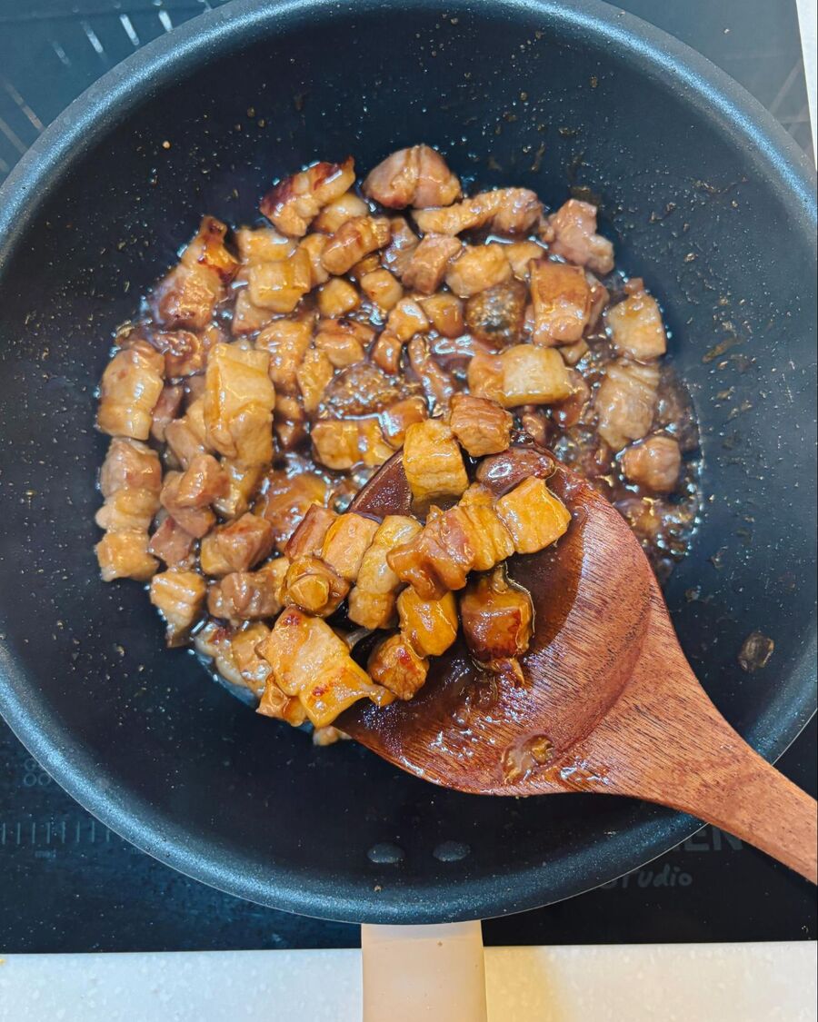 Add about 1 cup of water—just enough to cover the pork. Bring it to a boil over high heat, then reduce the heat to low and let it simmer for about 15 minutes, or until the sauce thickens. Turn off the heat.