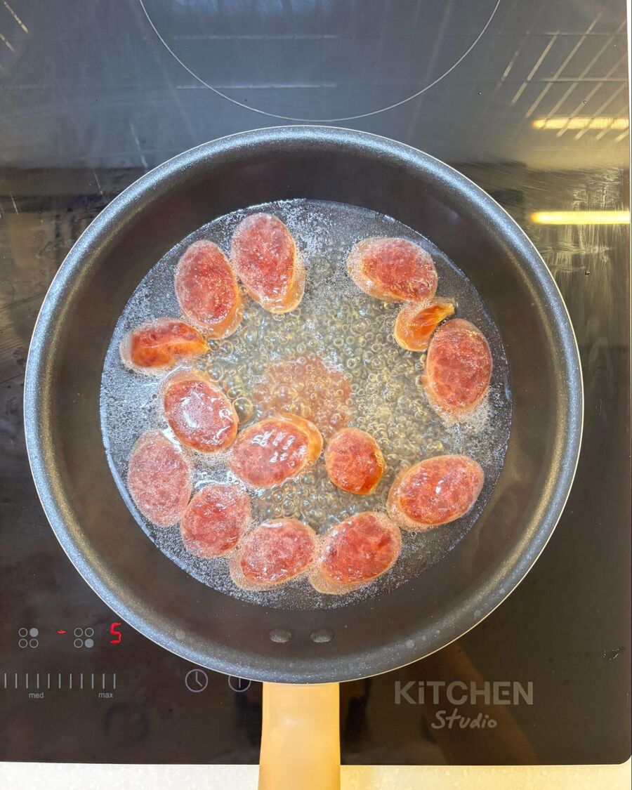 Place a pan over medium heat and add about ¼ cup of boiling water. Chop the Chinese sausage into small bite-sized pieces. Cook the sausage, stirring occasionally, until the water has mostly evaporated and the sausage starts to brown. Flip the pieces to brown the other side, then remove from the heat.
