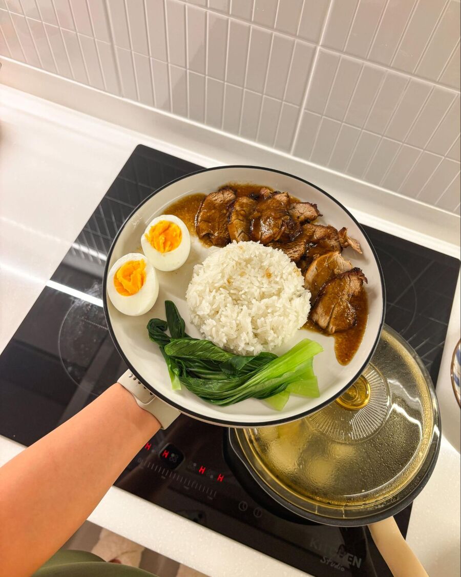 To plate the dish, start with a bed of steamed rice. Add the grilled pork on top, arrange some veggies and a boiled egg on the side, then pour the gravy sauce over the pork. Enjoy!