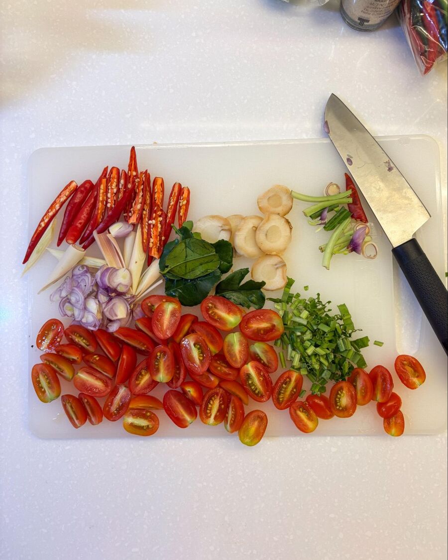 Chop all the herbs into small pieces, and slice half of the tomatoes.
