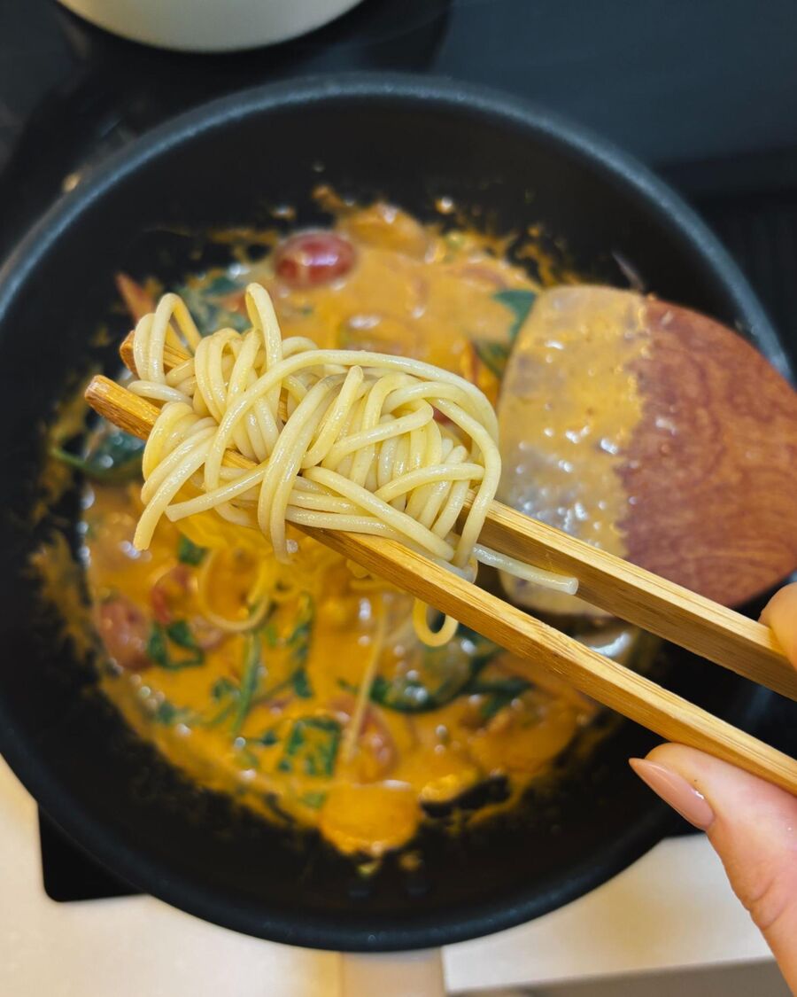 Once the Tom Yum sauce is ready, add the spaghetti and toss to combine.