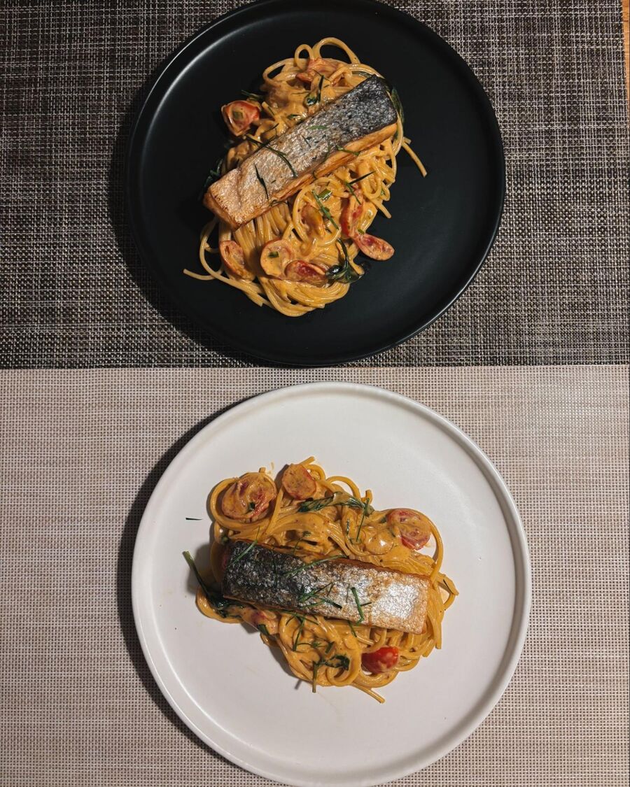Top the spaghetti with the fried salmon, garnish with kaffir lime leaves, and enjoy!