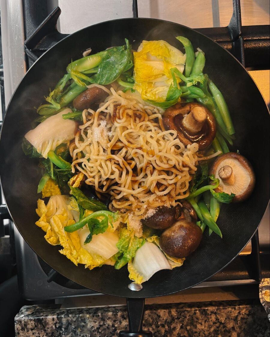 Push the vegetables to the sides to create a space in the center, then add the cooked egg noodles along with the mushroom sauce, soy sauce, and a little sugar. Push the vegetables to the sides to create a space in the center, then add the cooked egg noodles along with the mushroom sauce, soy sauce, and a little sugar.